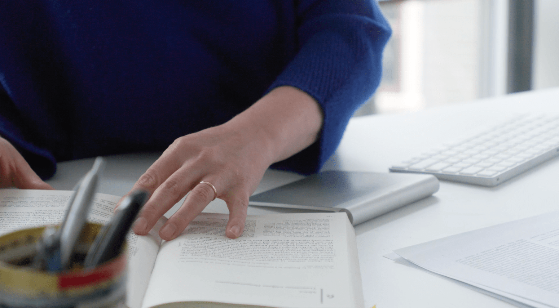 Closeup of hands opening a book