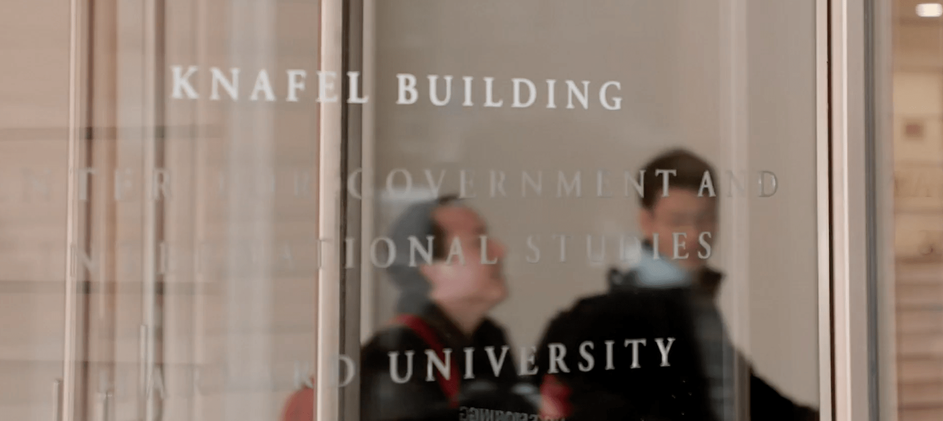 Graduate students walking into Knafel building